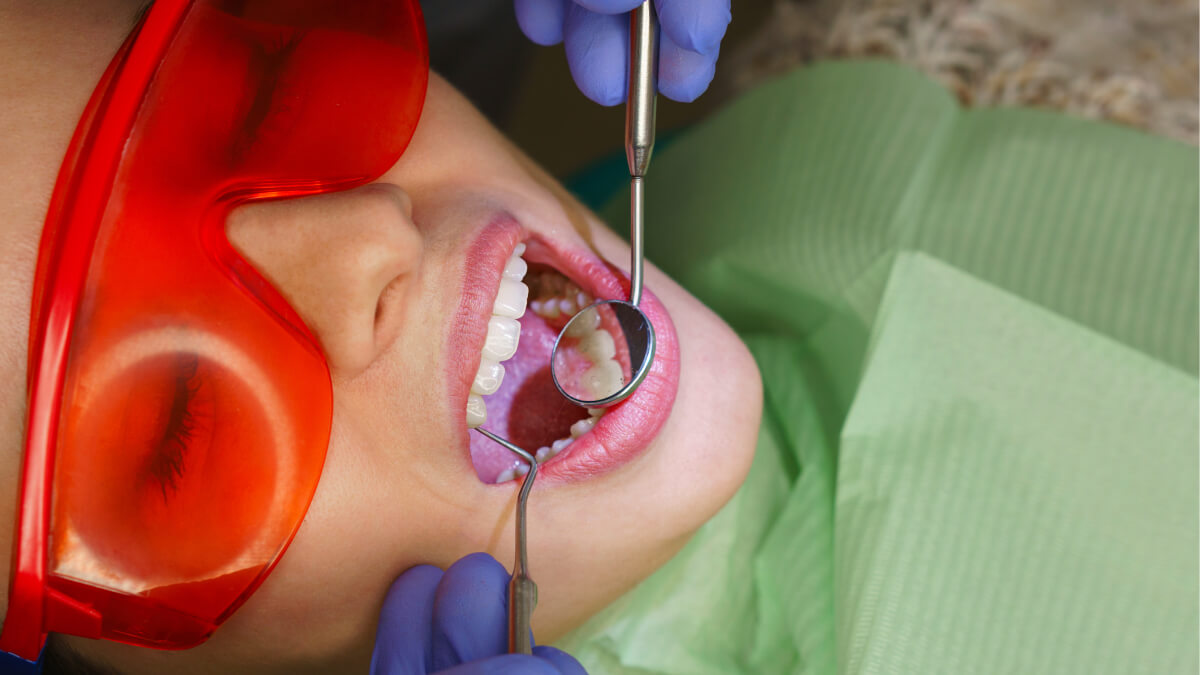 Girl getting teeth checked
